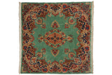 Vintage Kerman square rug with a scrolling floral medallion on a vibrant ocean green field with red and navy accents.