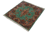 Angled view of the vintage Kerman rug showing its soft, full pile and ocean green color.