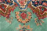 Detail of Rococo-stylized leaves and floral blossoms on a vintage Persian Kerman rug.