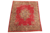 Vintage Kerman carpet with deep pink field, central floral medallion, and ornate floral borders.
