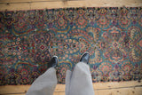 Fine Kerman runner's detailed floral blossoms and swirling vines in blue, pink, and purple.