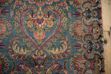 Traditional Persian Kerman rug, ornate floral blossoms and sprawling vines on blue.