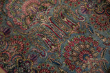 Intricate floral blossoms and budded vines in rose, sapphire, and lime green on a Kerman rug.