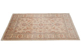 Ivory field Pakistani Sultanabad design carpet with flowing cinnabar red floral palmettes and blue vinery.