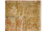 Oversize palmettes in the wide floral border of a vintage Agra carpet with intact fringed edge.