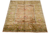 A vintage Agra square carpet's lustrous pile reflecting light across its floral design.