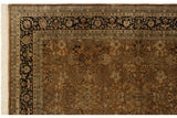 Corner of a vintage Indian carpet showing the navy blue floral border and intact ivory fringe.