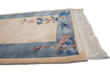 Art Deco rug corner showing thick sky blue border and raised pink and blue florals.