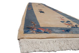 Ivory fringe, plush pile, and blue Art Deco border with floral designs.