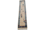 Art Deco rug corner with ivory field, sky blue border, floral sprays and butterfly.