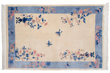 Vintage Chinese Art Deco carpet: ivory field, cobalt vased plants, butterflies, sky blue floral border.