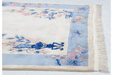 Ivory fringe, intact side cord, and sky blue floral border of vintage Art Deco carpet.