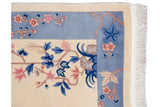 Vintage Art Deco carpet's ivory fringe and banded sky blue border with pink, blue floral sprays.