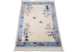 Light blue banded border and pink, blue floral sprays at Art Deco carpet corner.