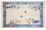 Corner of Chinese Art Deco rug showcasing cobalt blue vase motif and pink floral sprays.