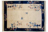 Vintage Art Deco carpet with ivory field, cobalt border, vased plants, and blue butterflies.