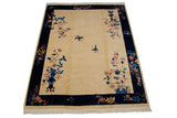 Art Deco rug corner; ivory field, cobalt border, vased plant, and blue butterfly.