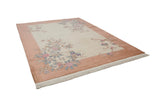 Angled view of Art Deco hand-knotted carpet, ivory field, dusty coral border, blooming pink and blue branches.