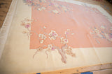 Shallow carved coral and ivory blossom motifs on a vintage Art Deco rug.
