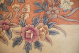 Shallow carved design of vintage Art Deco carpet with coral, ivory, and mauve roses.