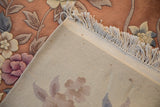 Vintage Art Deco carpet's hand-knotted reverse, original fringe, and carved coral floral pile.