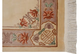 Vintage Peking rug corner with blush floral designs, geometric border, and clean ivory fringe.