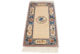 Peking runner corner with cobalt blue scrolling leaves, dusty sandalwood floral cartouches, and ivory fringe.