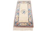 Corner of hand knotted Peking runner, ivory fringe, dusty sandalwood, blue floral cartouches.