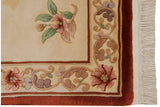 Vintage Peking rug corner detail: ivory field, cinnabar floral border, and full pile fringe.