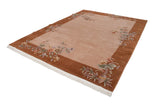 Art Deco carpet corner with fringed edge, copper border, and lotus floral sprays.