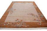 Vintage Art Deco carpet with dusty mauve field, copper border, and lotus flower sprays.