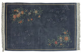 Vintage Chinese Art Deco carpet, denim blue with opposing vibrant floral and subtle vine designs.