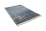Vintage Art Deco carpet with denim blue field, colorful floral sprays, and tone-on-tone vines.