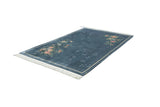 Chinese Art Deco carpet featuring diagonal floral sprays in full bloom on denim blue.