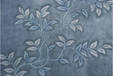 Subtle carved tone-on-tone blue vine pattern on a vintage Art Deco rug.