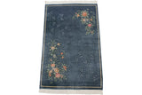 Denim blue Art Deco rug with diagonally opposing vibrant floral and subtle vine patterns.