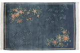 Chinese Art Deco rug corner detail: full bloom floral spray in terracotta, blush, green, and fringe.