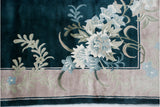 Exquisite sprawling floral blossom motif on vintage Art Deco rug's teal field and platinum border.