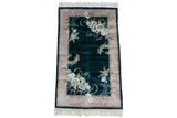 Vintage Chinese Art Deco rug corner with sprawling ivory and pale turquoise floral blossoms.