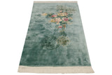 Pale aqua Japanese Peking rug with ivory fringe and intricate pictorial roundel medallion.