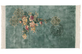 Detailed view of pictorial roundel medallion with hut on aqua vintage Japanese Peking rug.