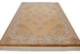 Corner detail of Peking Carpet: fringe, original copper selvage, and floral motifs.