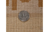 Even hand-knotted pile of vintage Peking carpet in beige and copper, with quarter for scale.