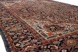 Angled view of a vintage Bakshaish carpet's intricate floral design and unique sapphire blue side border.