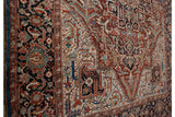 Angled detail of a Persian Bakshaish carpet's complex floral border and unique sapphire blue edge.