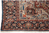 Corner of a collector Bakshaish carpet showing the floral spandrel, sapphire blue border, and fringe.
