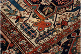 Close-up of a vintage Bakshaish corner spandrel showing sprawling floral arabesques and time-softened tones.