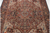 A full perspective of a vintage Bakshaish collector carpet featuring its large medallion and intricate floral spandrels.