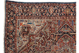 Floral arabesque border and solid sapphire blue edge on a vintage collector Bakshaish carpet corner.