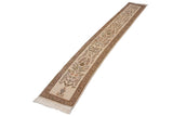 Angled view of a vintage Tabriz runner showing the continuous floral branch design.